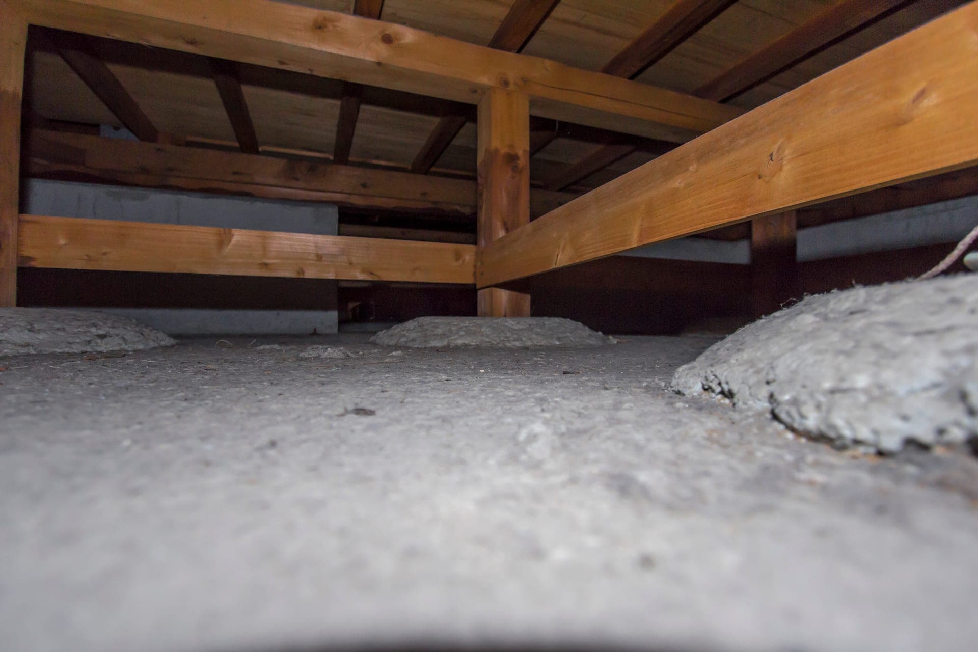 A bare dirt crawl space under a Missouri home before encapsulation